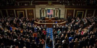 Legislative chamber audience stands and applauds