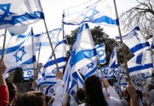 Jewish Americans Debate Antisemitism and Israel Crowd waving Israeli flags outdoors