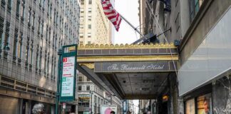 Andreas Hestler and pedestrians outside The Roosevelt Hotel entrance on a city sidewalk