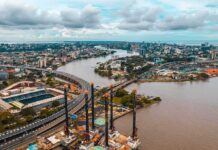 Aerial view of a river cutting through a modern city with bridges and ports
