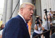 Trump Faces Major Setbacks in One Week man in suit speaking to media outside a courthouse
