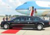 Presidential limousine beside a large blue-and-white jet on a runway