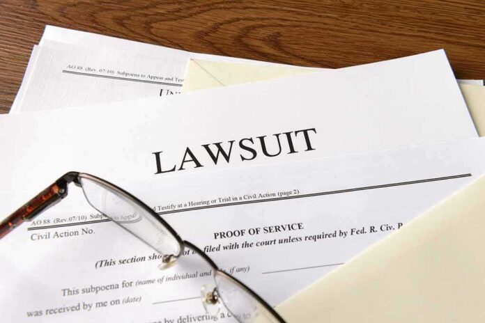 shutterstock_334984976 Legal documents labeled lawsuit on a desk