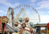 Toddler Falls From Boardwalk Sky Ride Colorful amusement park scene featuring a ferris wheel and carousel