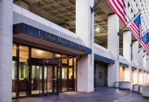$9.5B Paid Leave Estimate Raises Questions J. Edgar Hoover FBI Building entrance with American flags