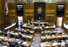 Legislative chamber with lawmakers debating a bill