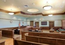 Dallas Cheerleaders Take Legal Aim at Rock Concert Empty courtroom with wooden benches and judge's bench