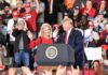Trump’s Joke About Senator’s Physique Goes Viral Donald Trump and Russ Huesman on stage at a rally podium