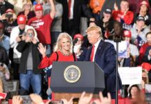 Donald Trump and Russ Huesman on stage at a rally podium