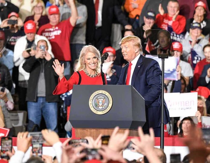 shutterstock_1629769585 Donald Trump and Russ Huesman on stage at a rally podium