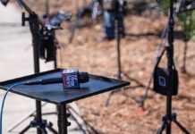 Trump’s Press Secretary Signals Closer Media Ties Microphone on a small stand-up table at an outdoor media setup