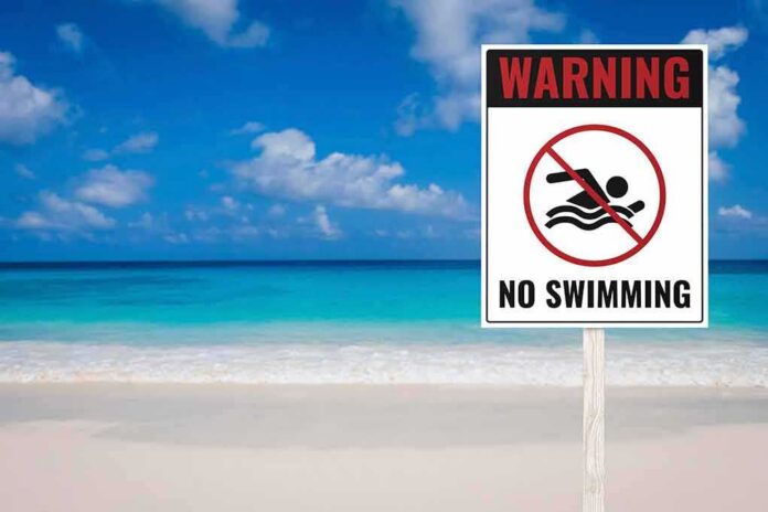 shutterstock_1824743135 No swimming warning sign on a tropical beach