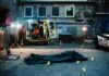 crime scene with body bag in alley