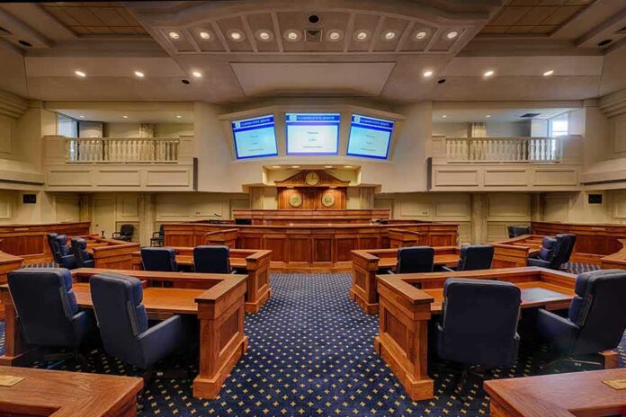 shutterstock_242072563-1 Courtroom interior with wooden benches and judge's bench