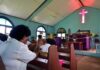 Congregation inside a church with a speaker at the pulpit