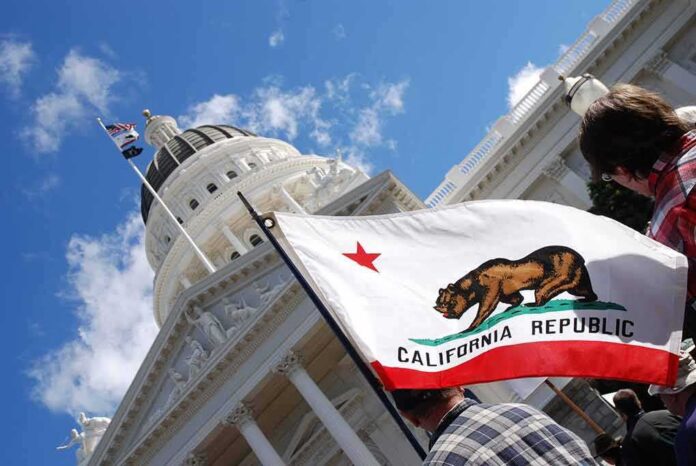 shutterstock_642199051-1 California state flag in front of a white domed capitol building