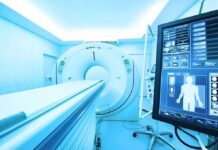 MRI or CT scanner with control monitor in hospital room