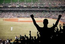 Milwaukee Ends 55-Year Championship Wait Crowd of fans cheering at a baseball game in a stadium